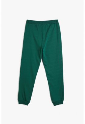 Pantaloni conici de trening cu buzunare oblice