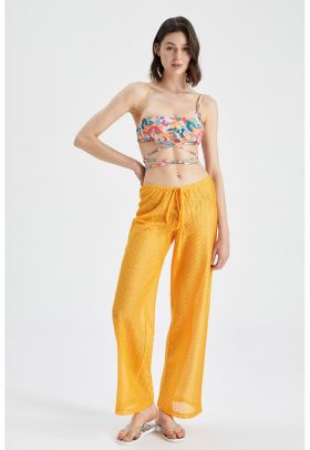 Pantaloni semitransparenti de plaja